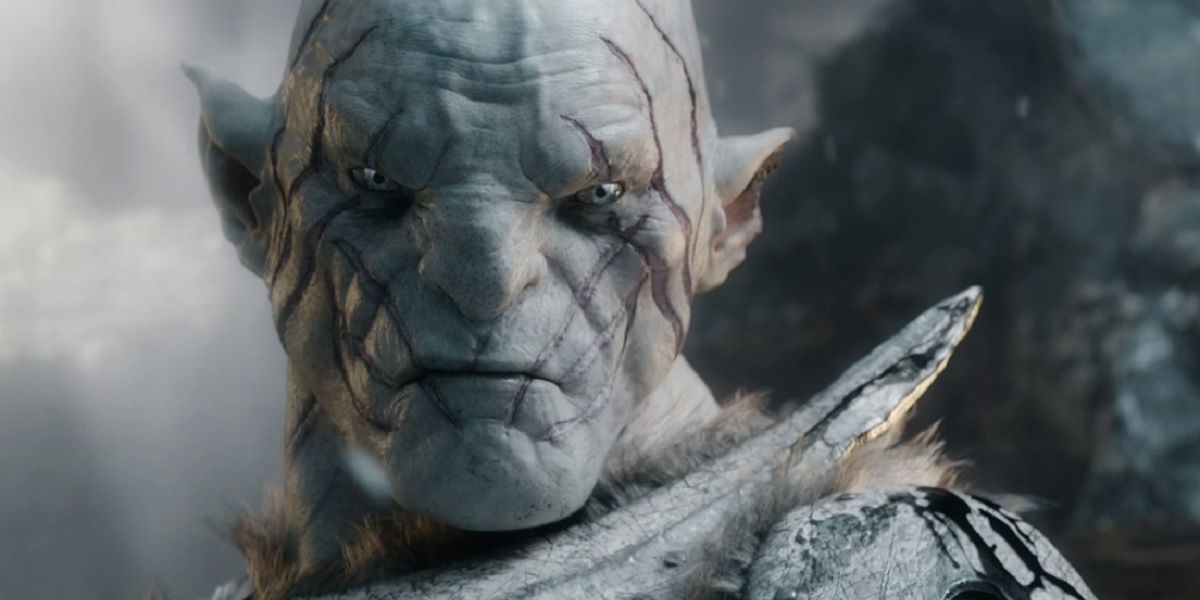Azog the White Orc looking down at something in The Hobbit.