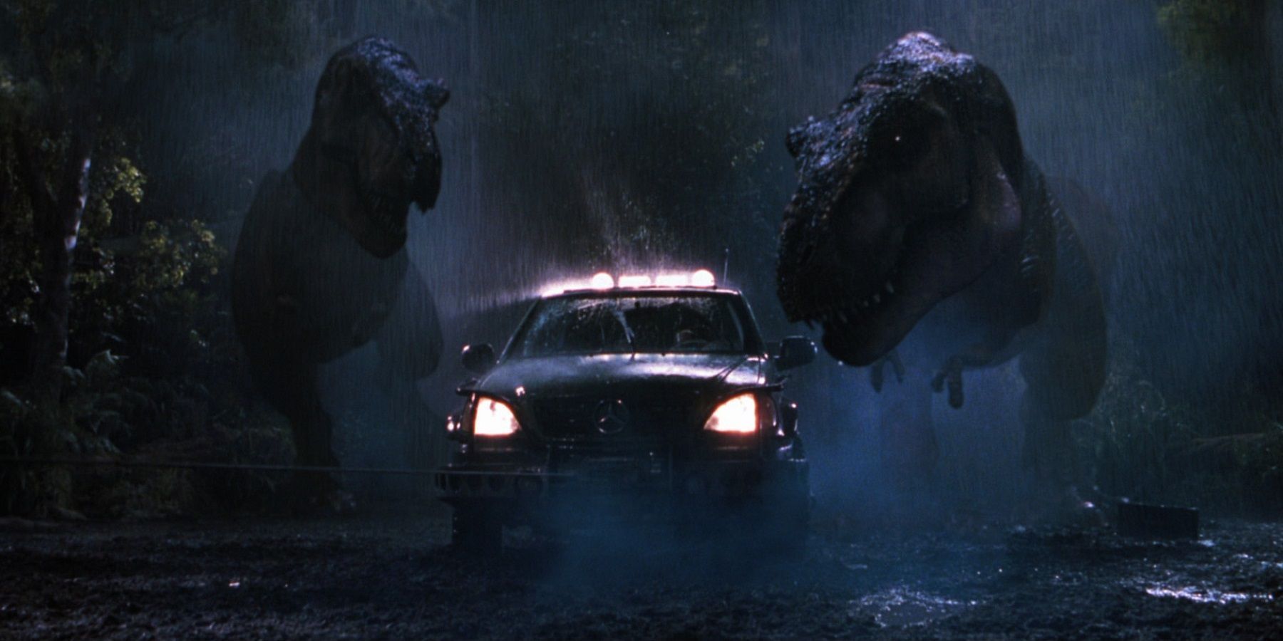 Two dinosaurs chase a car in The Lost World Jurassic Park