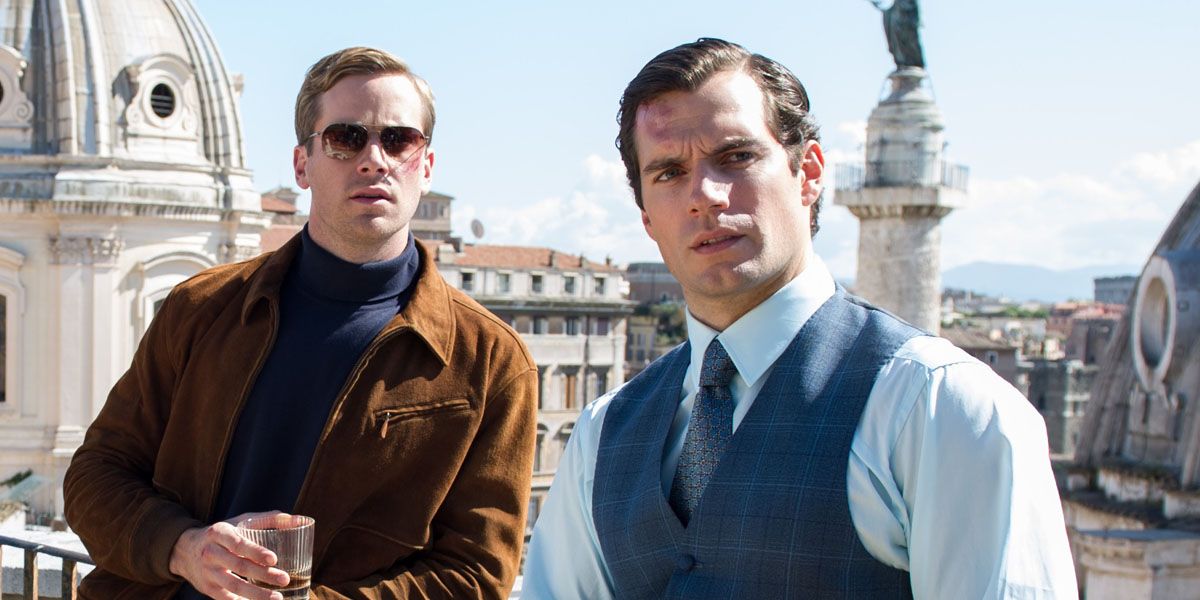 Armie Hammer and Henry Cavill look at the camera in The Man from U.N.C.L.E.