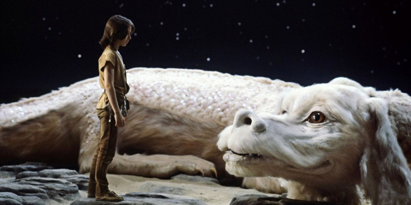 The little boy and Falcor looking at each other in The NeverEnding Story