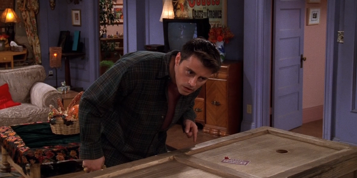 Joey leaning over the box in Friends