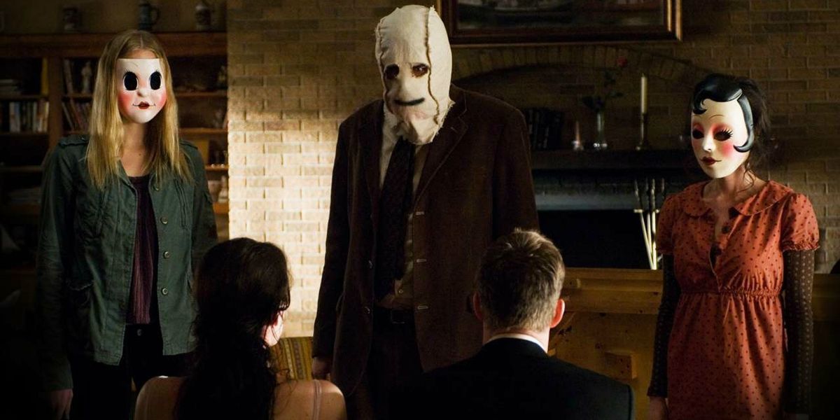 Three people wearing masks in The Strangers