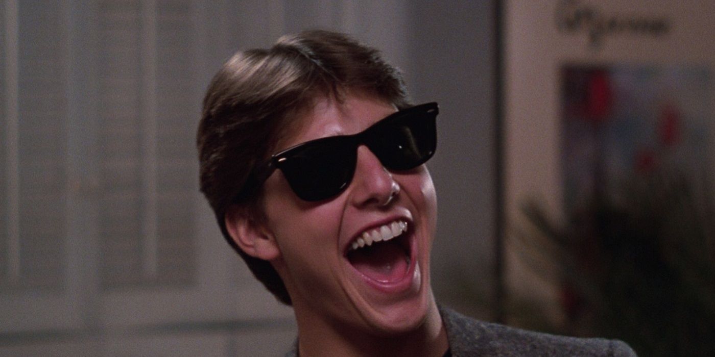 Tom Cruise laughs while wearing sunglasses from Risky Business 