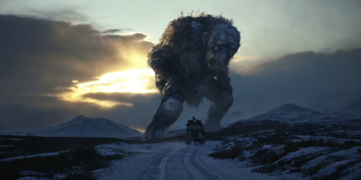 A car coming across a jotnar troll in the middle of the road in Trollhunter