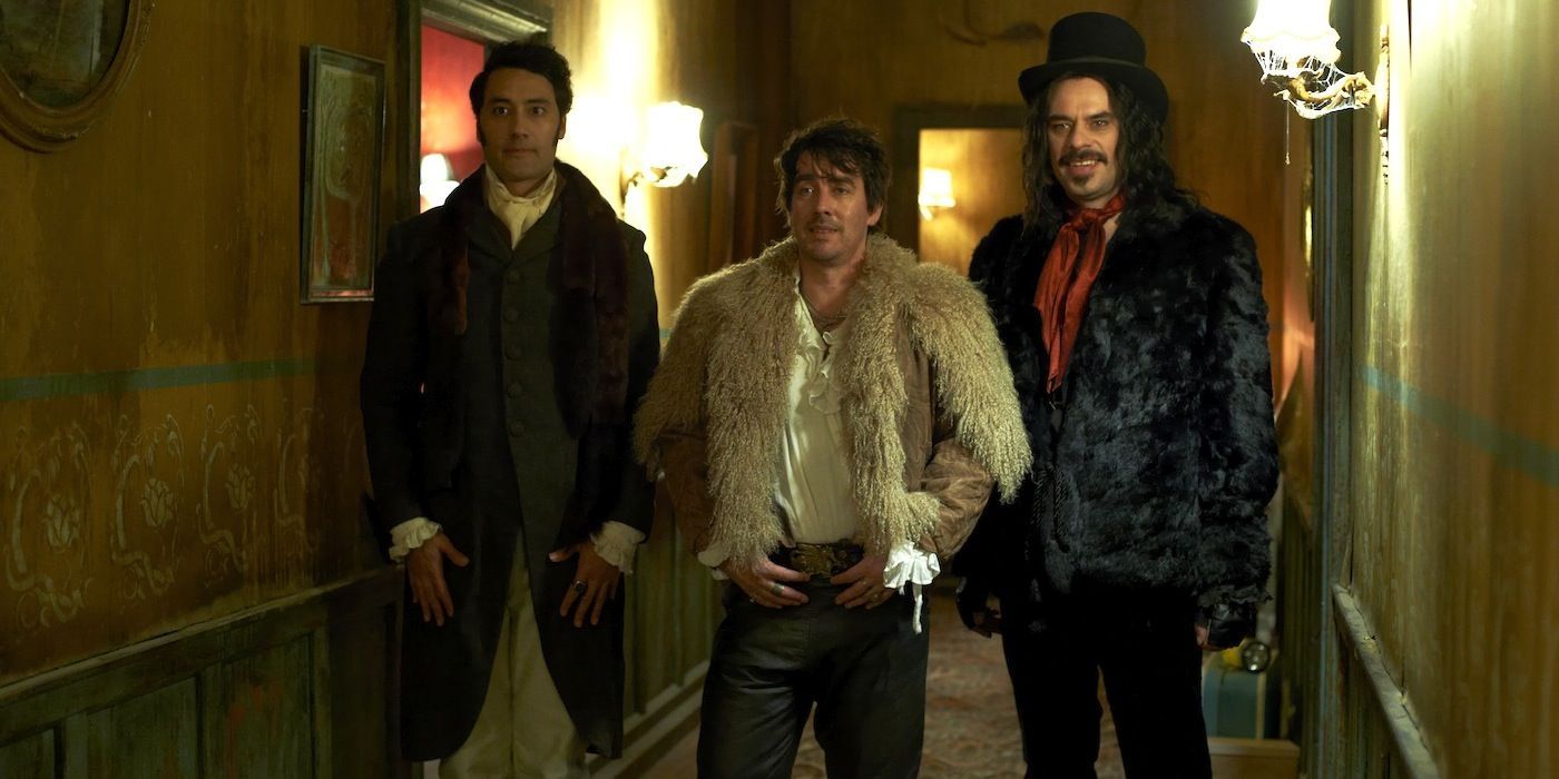 Vampires look suspect in a hallway in What We Do In The Shadows (2014)