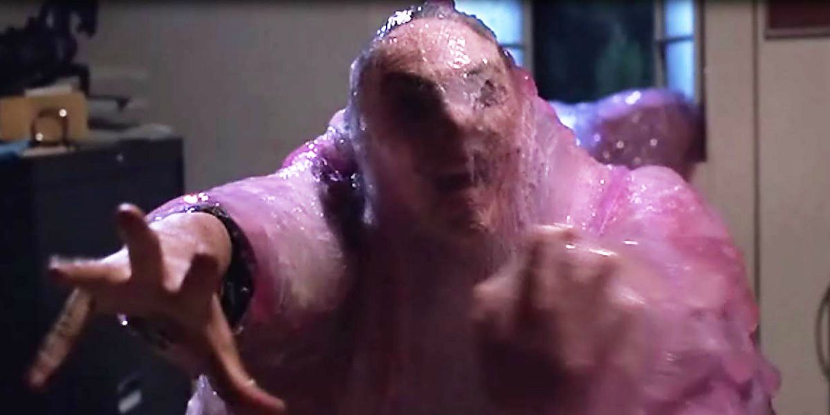 Guy trapped in the blob reaching out in The Blob