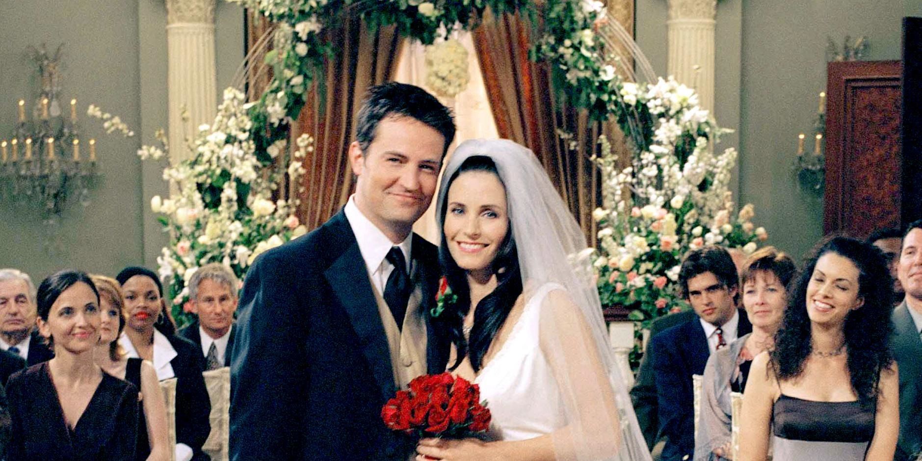Chandler and Monica pose for a photo after their wedding in Friends