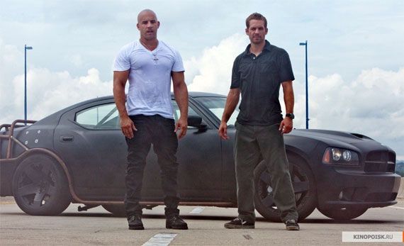Vin Diesel and Paul Walker stand by a cool car in Fast Five