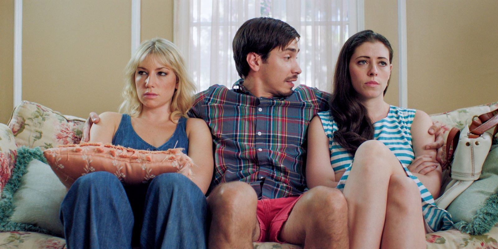 Justin Long sits between two roommates in For a Good Time, Call