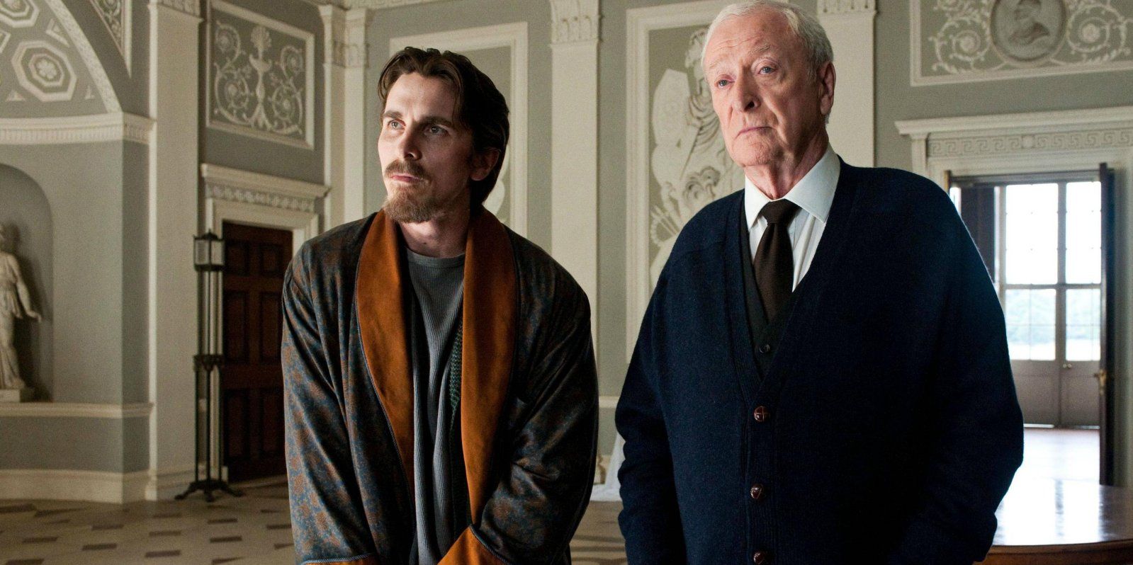 Christian Bale as Batman/Bruce Wayne and Michael Caine as Alfred Pennyworth