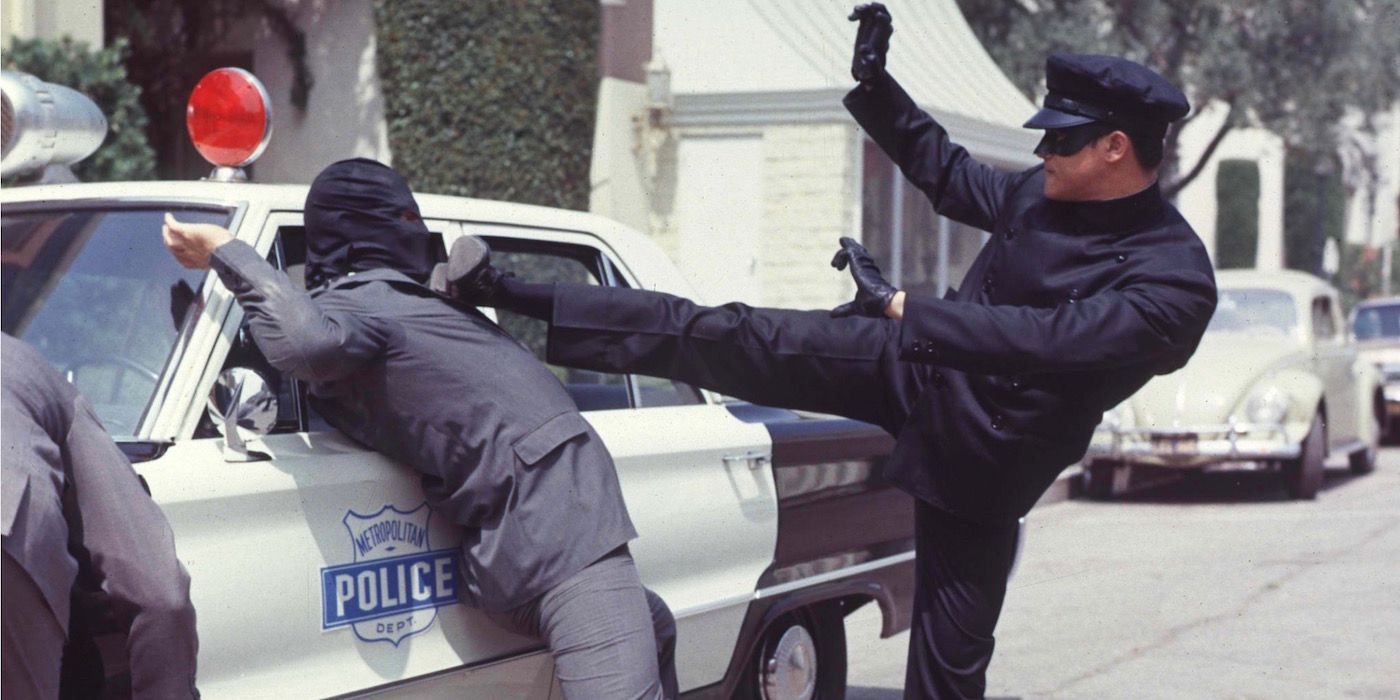 Kato kicks an enemy against a police car in The Green Hornet