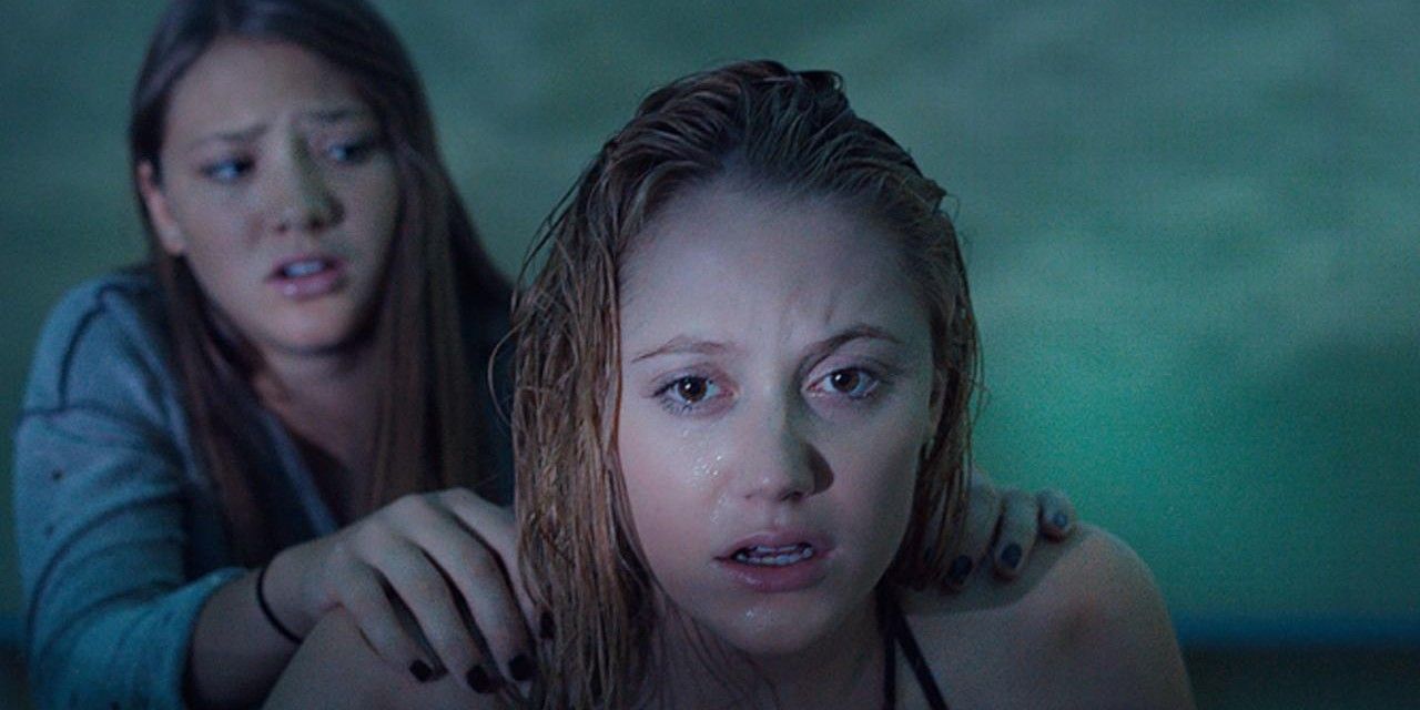 A friend holds onto another in It Follows