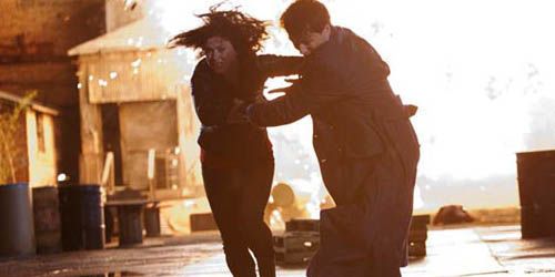 jack and gwen run from an explosion in the torchwood finale