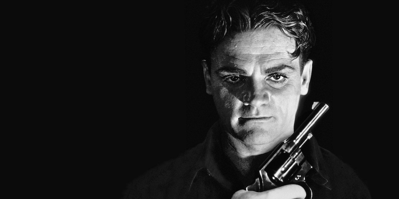 James Cagney holding a gun against a black backdrop