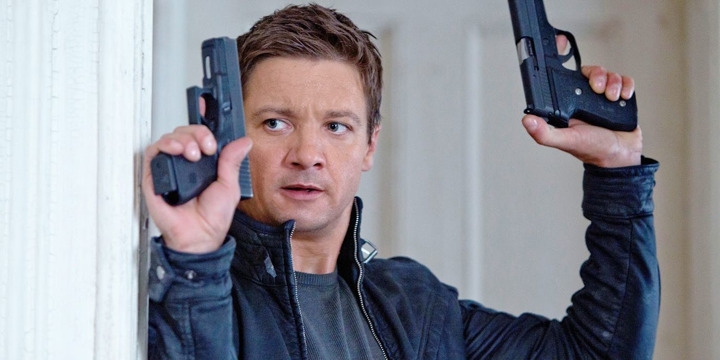 Aaron Cross holding up two weapons in The Bourne Legacy