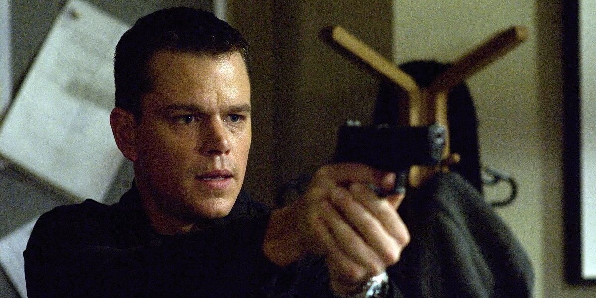 Jason Bourne aiming a gun in The Bourne Identity.