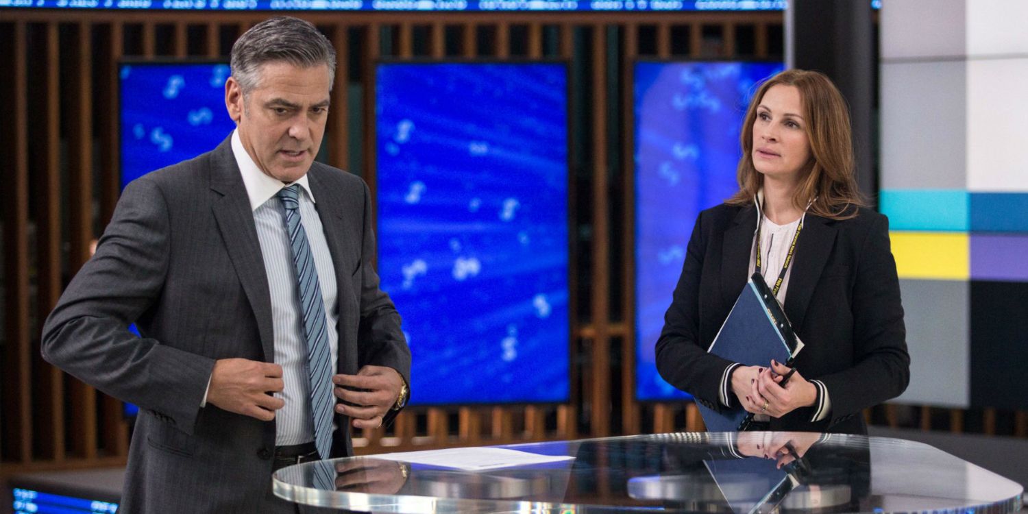 George Clooney and Julia Roberts standing around a table in Money Monster.