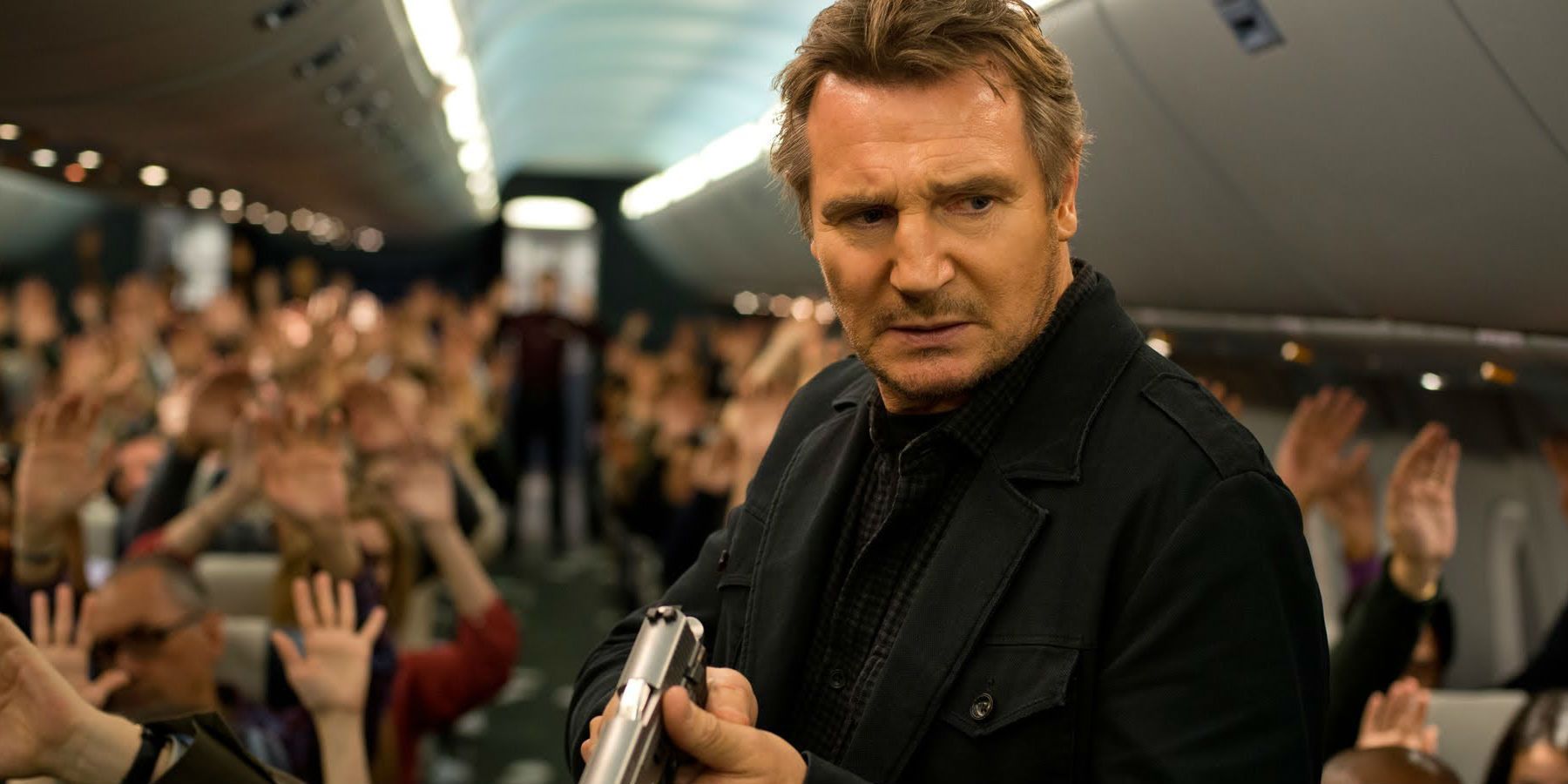Liam Neeson holding a gun in Non-Stop.
