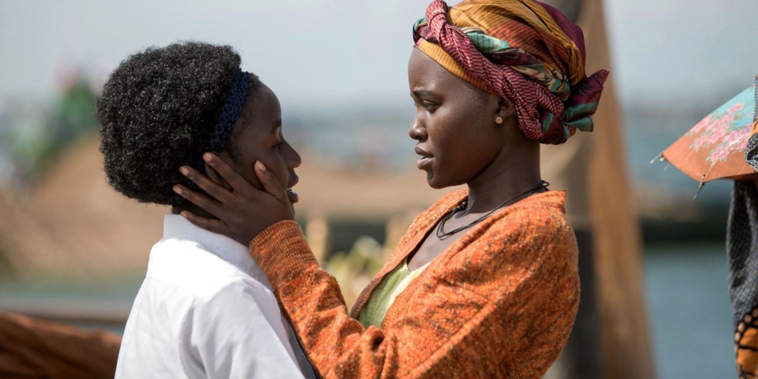 Lupita Nyong'o holding Madina Nalwanga's face in Queen of Katwe. 