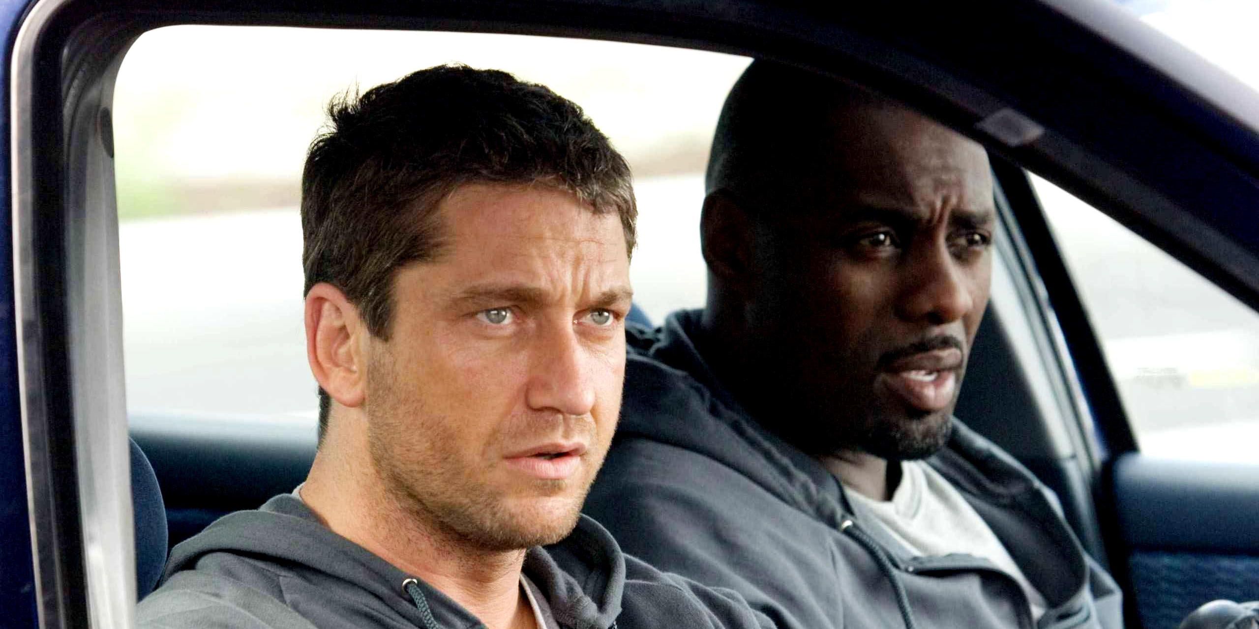 Gerard Butler as One-Two and Idris Elba as Mumbles sitting in a car in RocknRolla