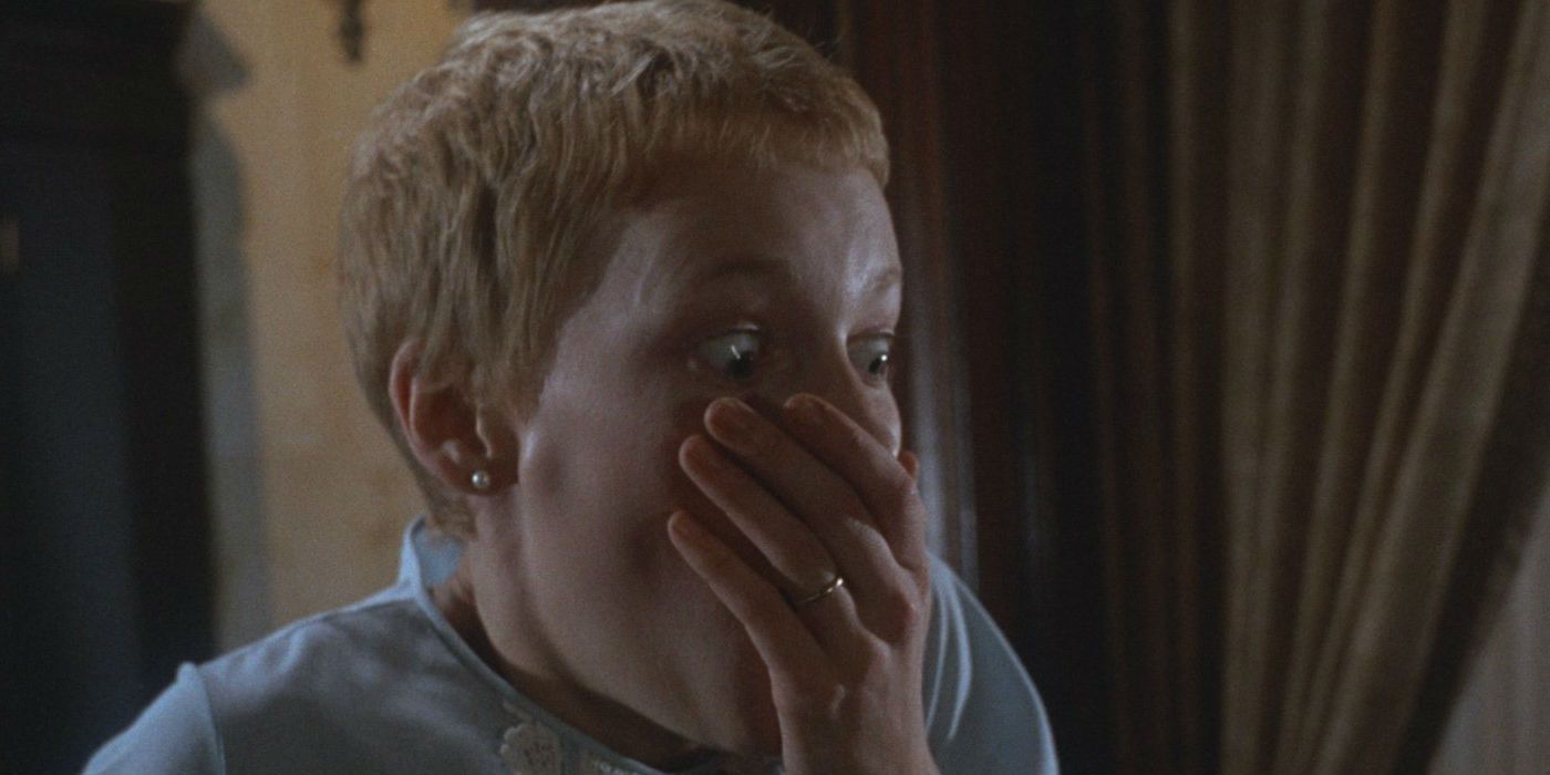 Rosemary scared and covering her mouth in Rosemary's Baby