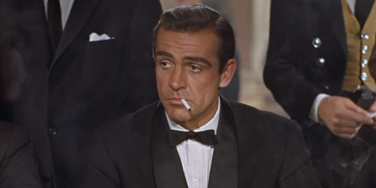 Sean Connery as James Bond smoking a cigarette in Dr. No