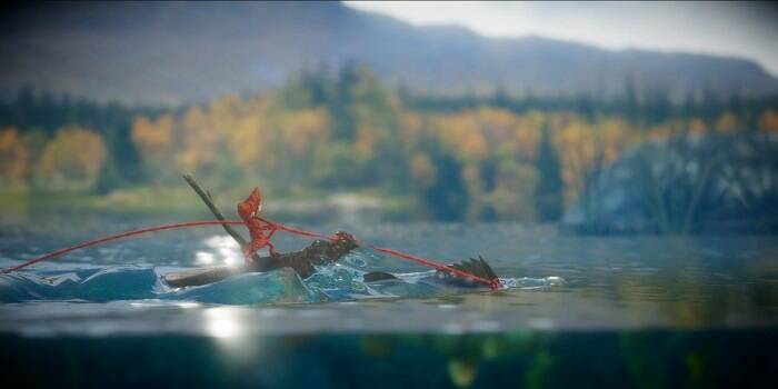 Yarney is on a log in the river in Unravel.