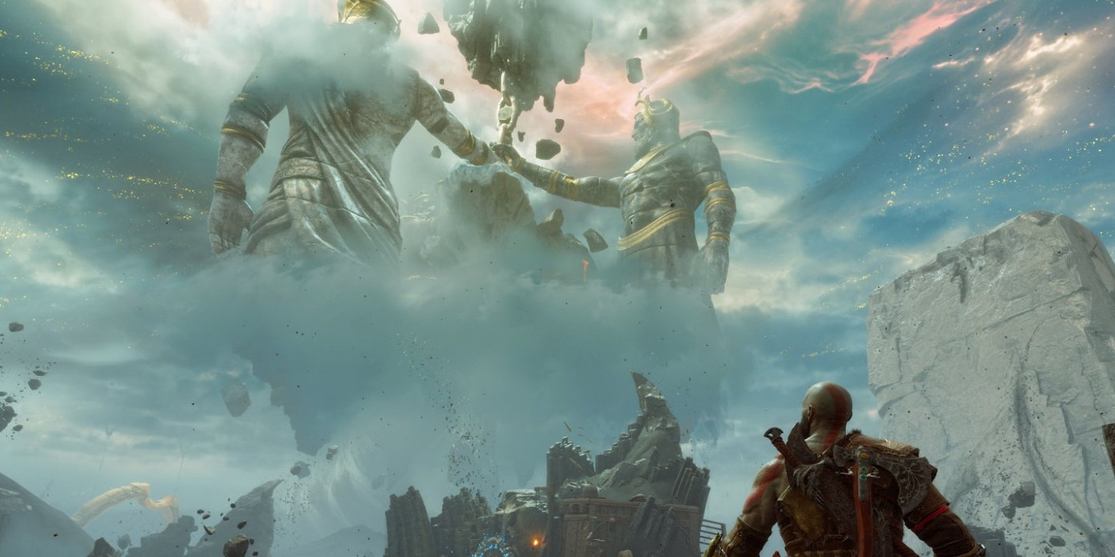 Kratos gazing at colossal statues in a mystical, cloudy landscape in God of War Ragnarok.