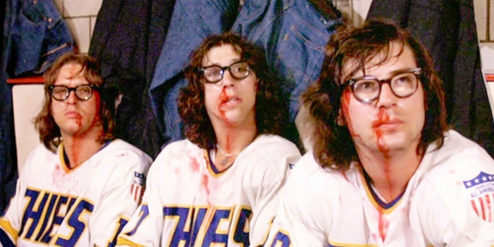 Cast of Slap Shot on the bench with bloody noses.