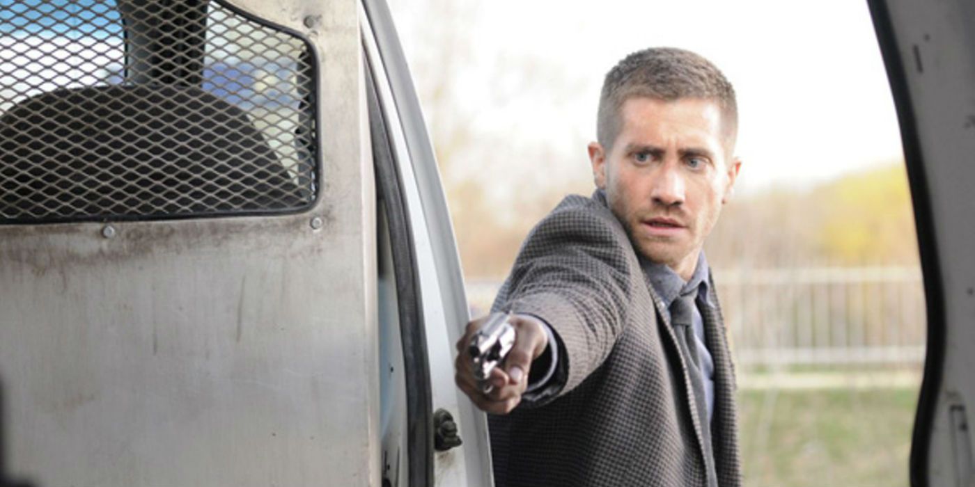 Jake Gyllenhaal pointing a gun in a van in Source Code