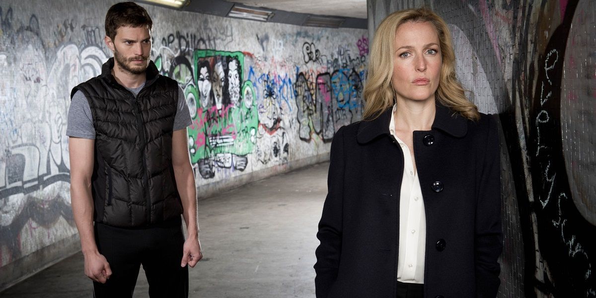 Jamie Dornan stares at Gillian Anderson in an alley in The Fall.