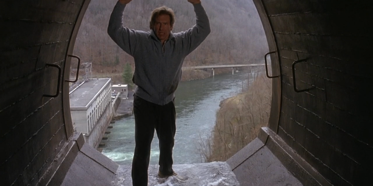 Harrison Ford stands with his hands up in a tunnel from The Fugitive 