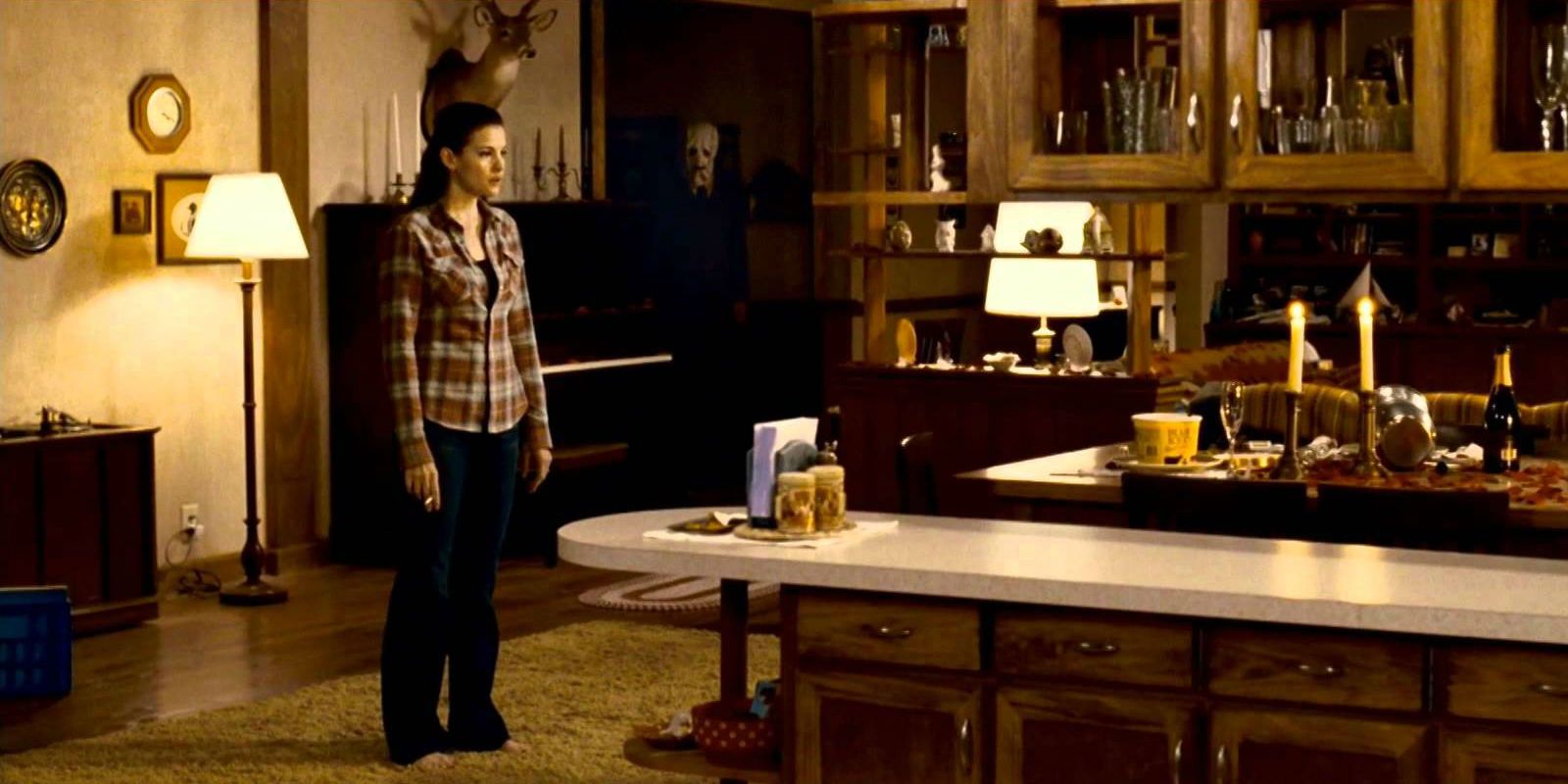 Liv Tyler with an intruder in the house in The Strangers