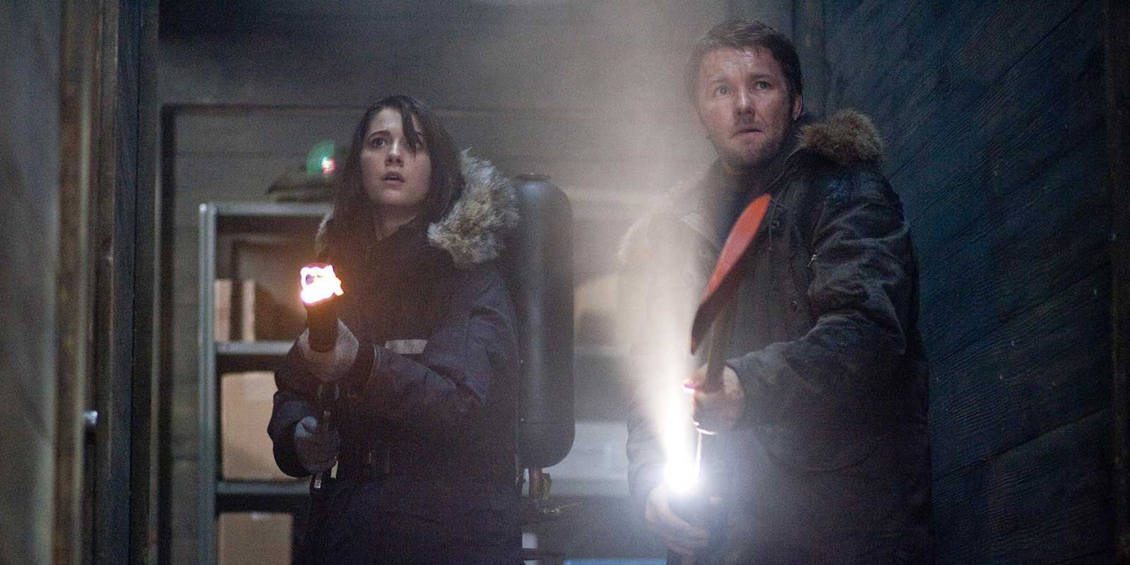 Carter and Kate point their weapons in The Thing 2011