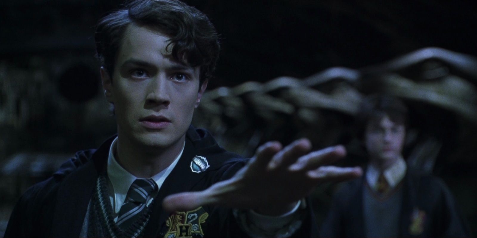 Tom Riddle reaching out a hand in Harry Potter.