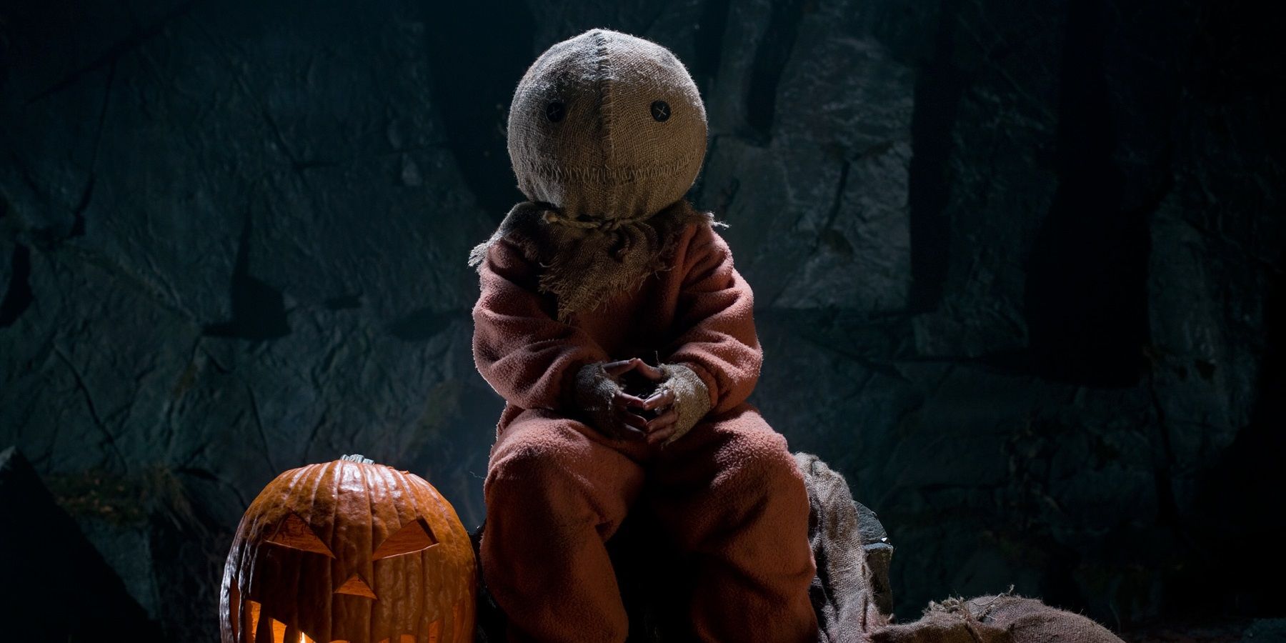 Sam sitting near a pumpkin in Trick 'r Treat