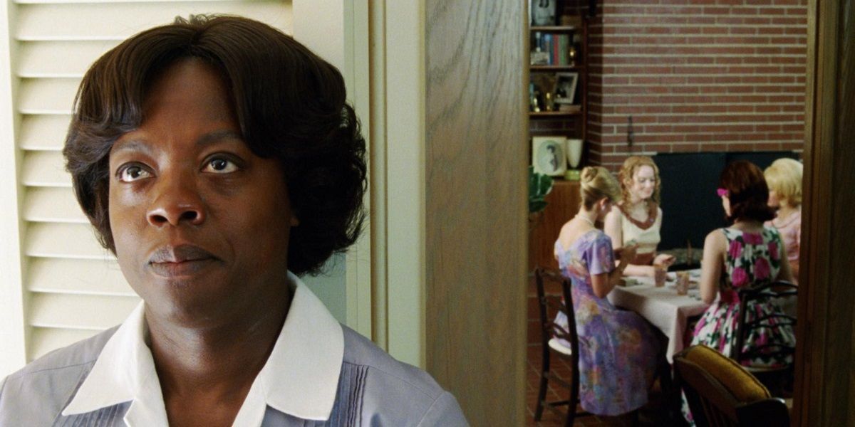 Viola Davis stands outside of a room full of women from The Help