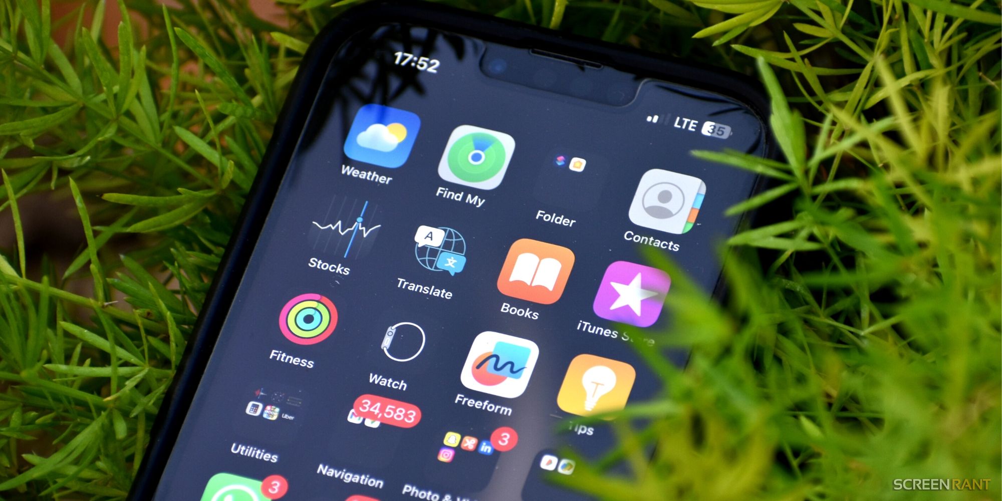 Image of the iPhone's home screen with multiple apps on a dark background