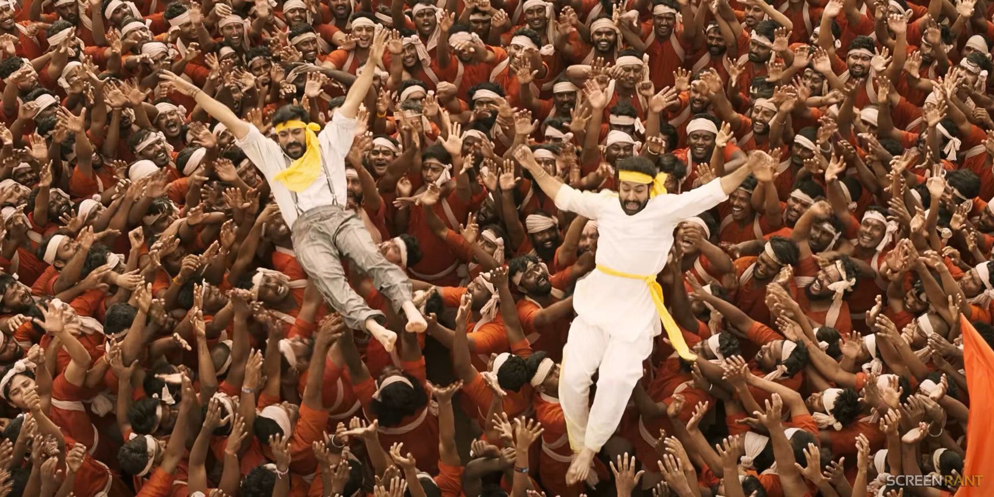 Raju and Bheem being lifted by a crowd in RRR Movie