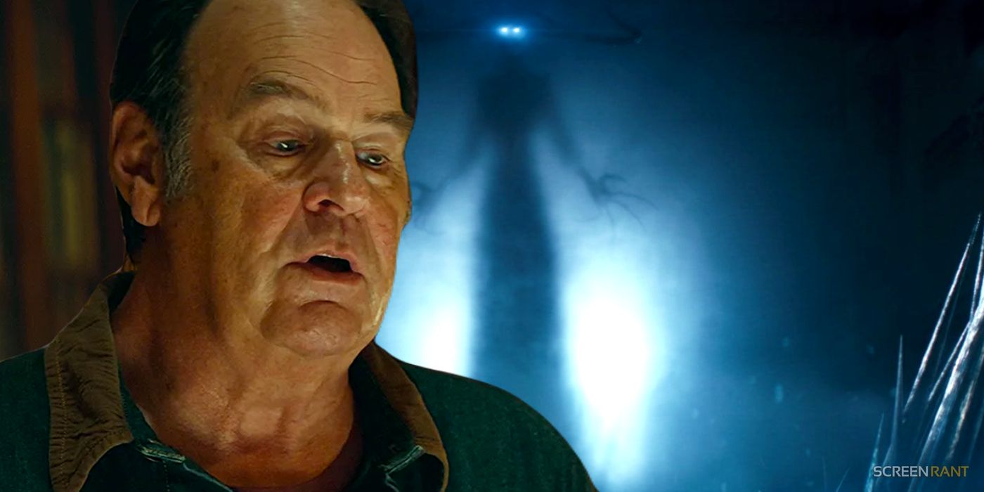 Dan Aykroyd as Ray with his mouth open in Ghostbusters Frozen Empire, and Garraka the ghost with glowing blue eyes next to him