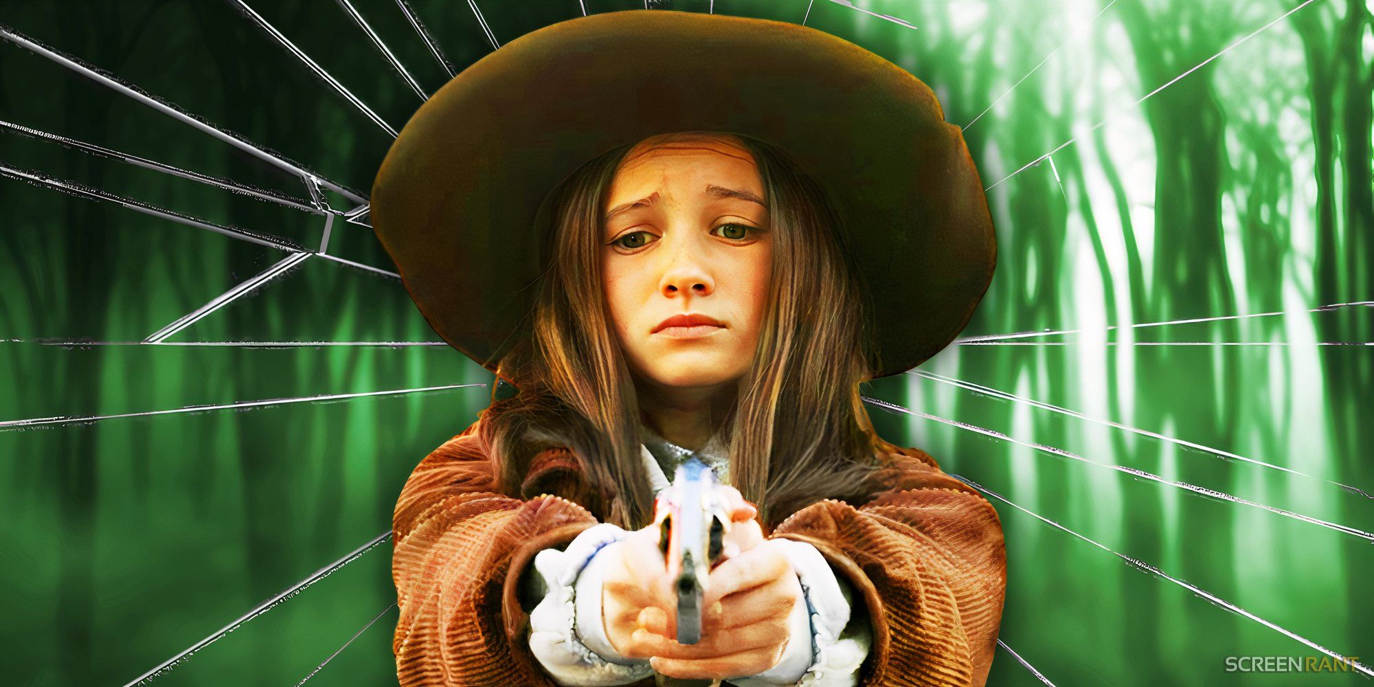 Cailey Fleming as Judith pointing a gun in front of cracked glass in The Walking Dead.