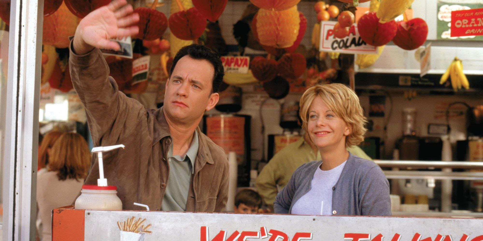 Kathleen (Meg Ryan) and Joe (Tom Hanks) look out the window of a restaurant in You've Got Mail.