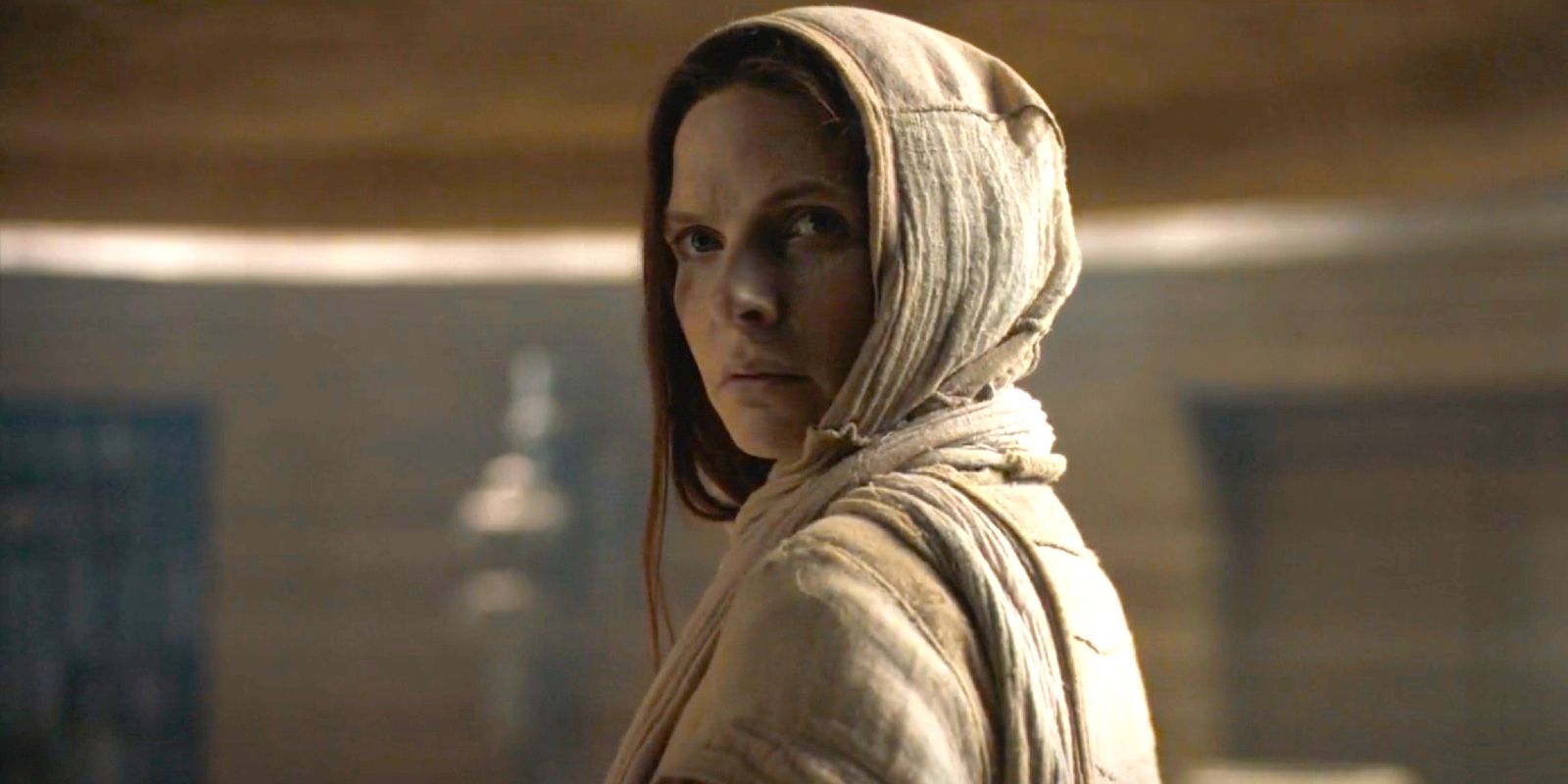 Rebecca Ferguson as Lady Jessica wearing a hood looking concerned in Dune