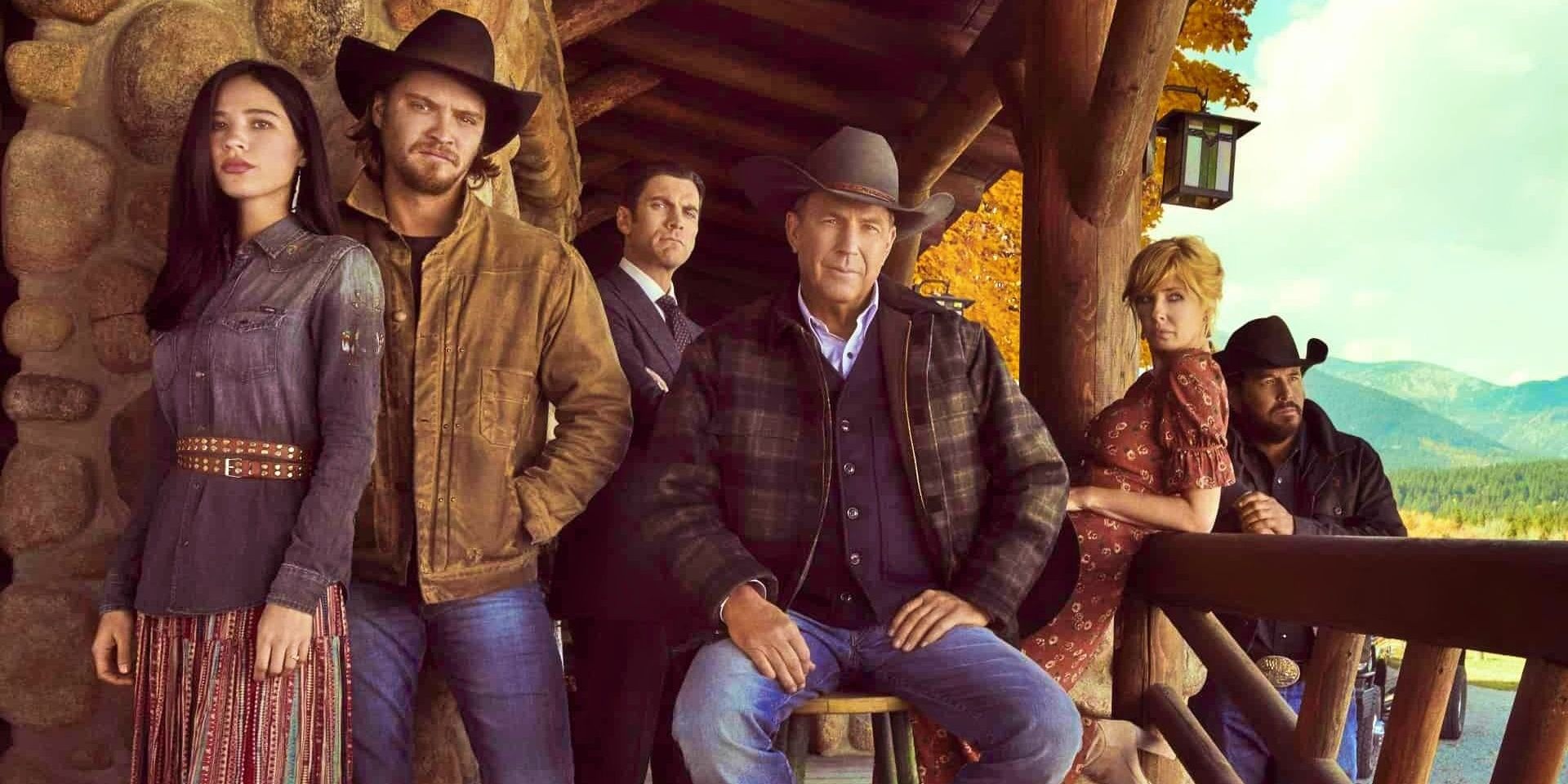 The cast of Yellowstone on a cabin porch