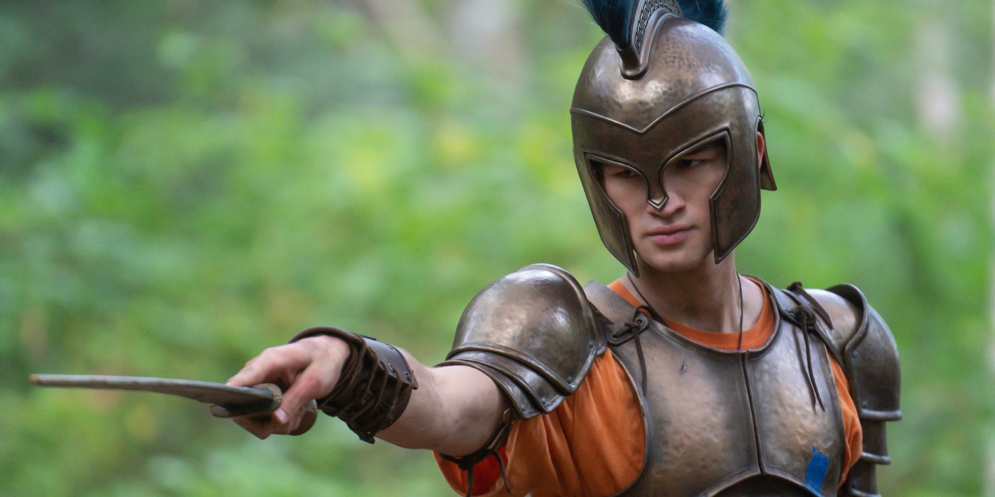 Charlie Bushnell as Luke wearing armor and holding a sword in Percy Jackson