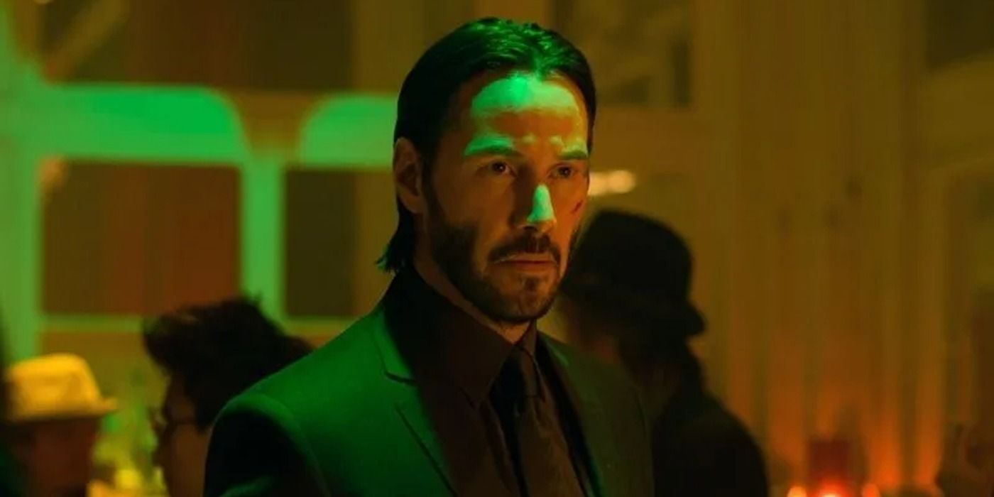 Keanu Reeves with Green Neon Light Shining on His Face in John Wick 