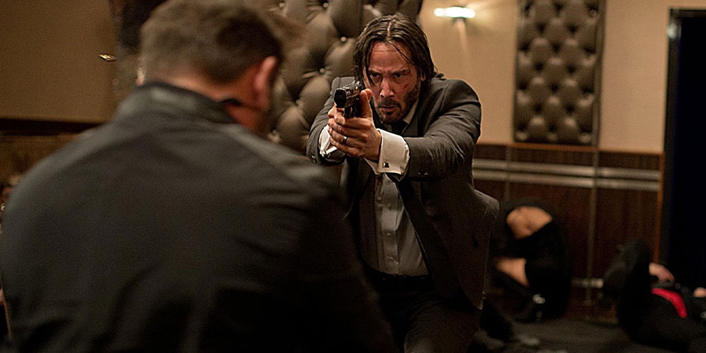 Keanu Reeves as John Wick Holding a Gun Up in John Wick