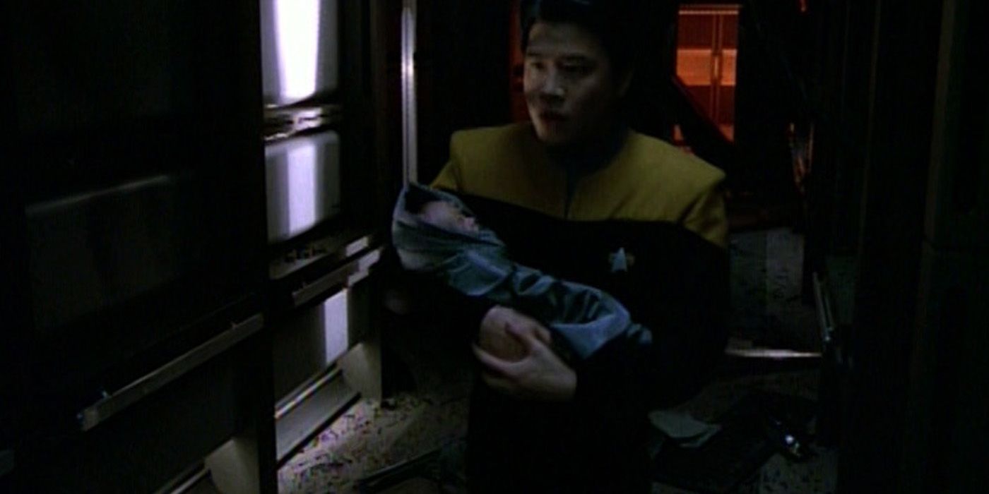 Garrett Wang as Harry Kim with baby Naomi Wildman in Voyager Deadlock