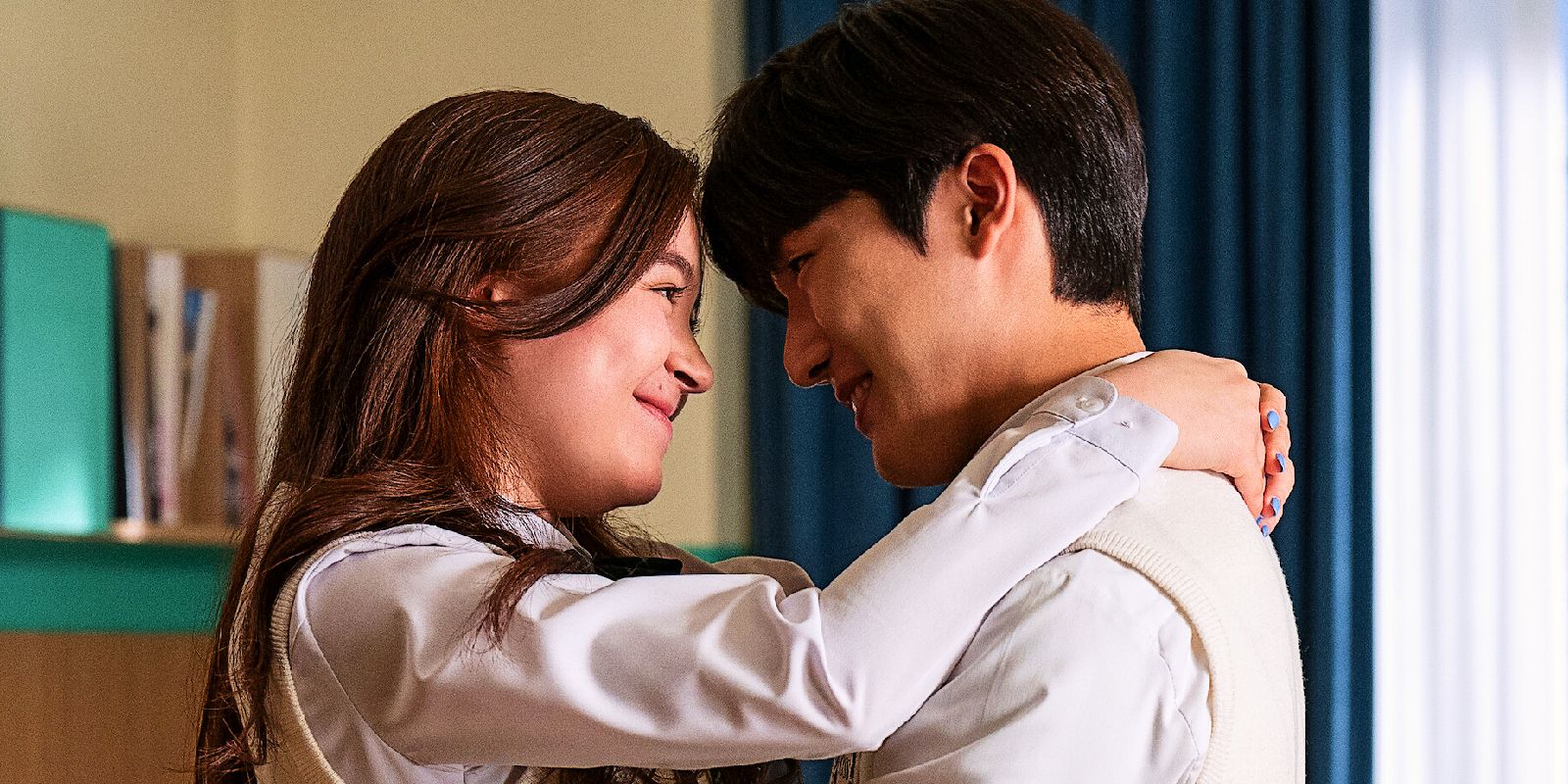 Kitty and Dae put their foreheads together while she has her arms around his neck in XO, Kitty.