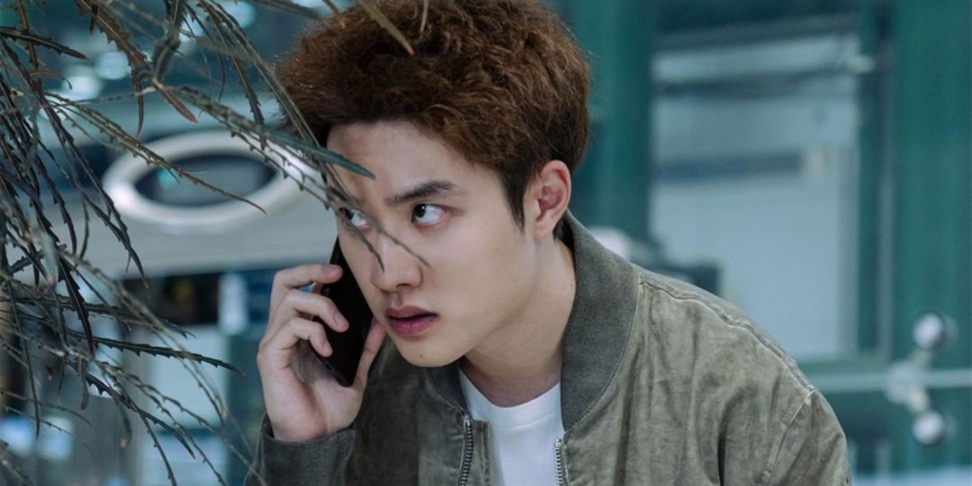 D.O. from Exo as Jin Jung hiding behind a plant on the phone in Bad Prosecutor